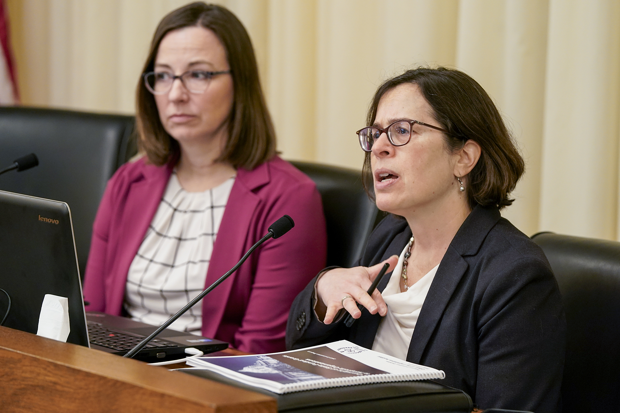 Legislative Auditor Judy Randall, right, reviews a 2023 report on state-funded grants to non-profit organizations during the first meeting of the House Fraud Prevention and State Agency Oversight Policy Committee Feb. 10. (Photo by Michele Jokinen)